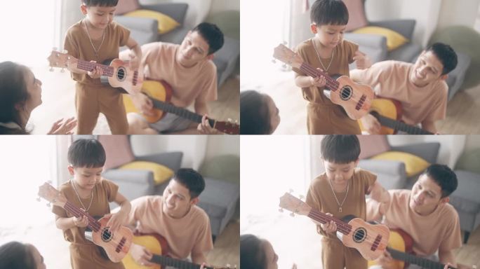 快乐的亚洲家庭在家里唱歌和弹吉他
