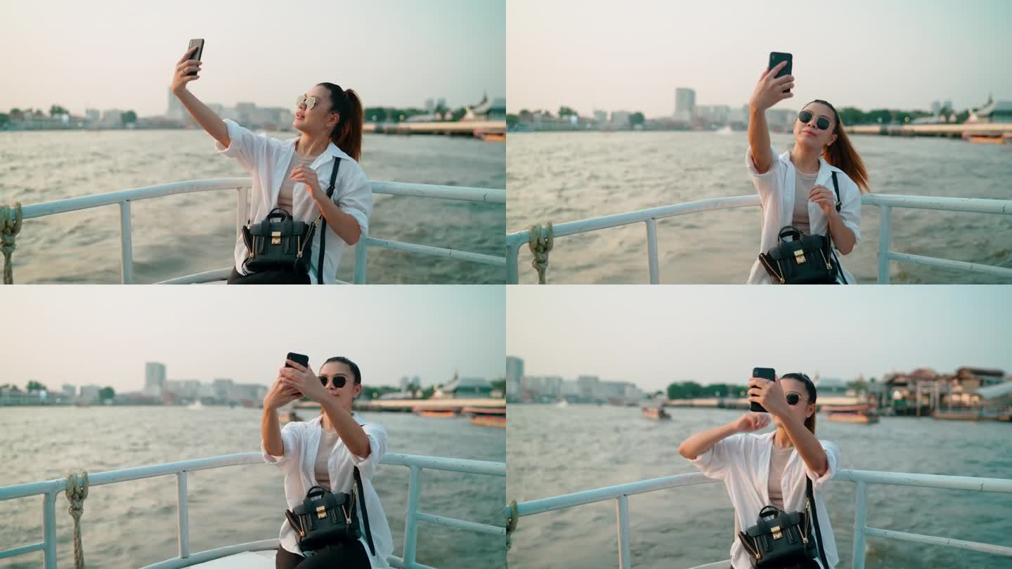 一名亚洲女子在寺庙附近的船上与朋友进行视频通话。