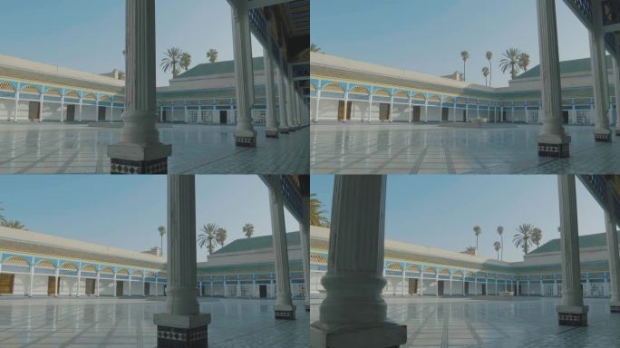 漫步在摩洛哥马拉喀什巴伊亚宫装饰精美的墙壁内的圆柱上，古老的马赛克墙壁，石头地板和蓝色的天空