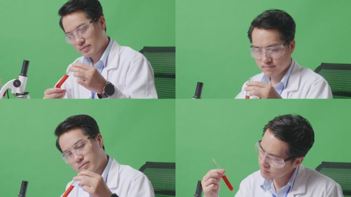 在绿屏背景的实验室里，亚洲男科学家一边看试管里的红色液体一边用显微镜在桌子上摇头的侧视图特写
