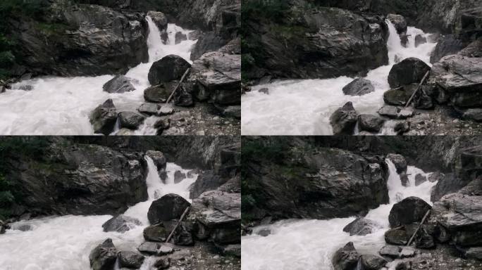 静拍强大的瀑布，岩石，灰色的山脉，湍急的河水