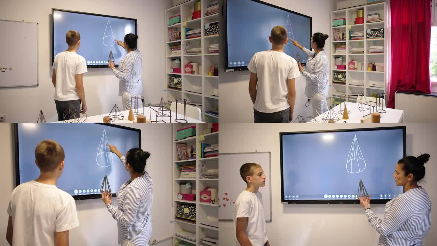 女几何老师在互动白板上画几何图形，与一名男生进行一对一的教学