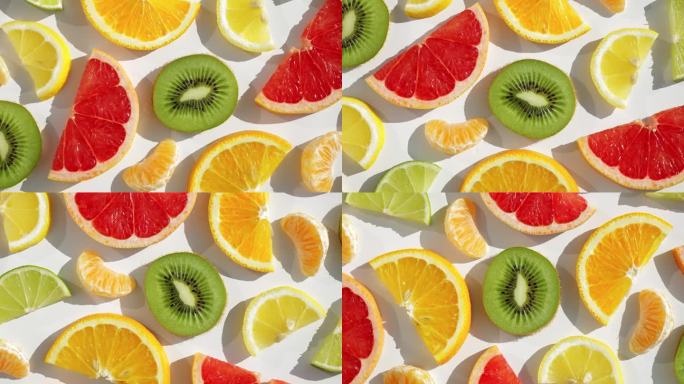 夏季新鲜水果小吃概念。维生素C.图案切片新鲜柑橘类水果柚子，橙子，柠檬，酸橙，猕猴桃旋转转孤立的白色