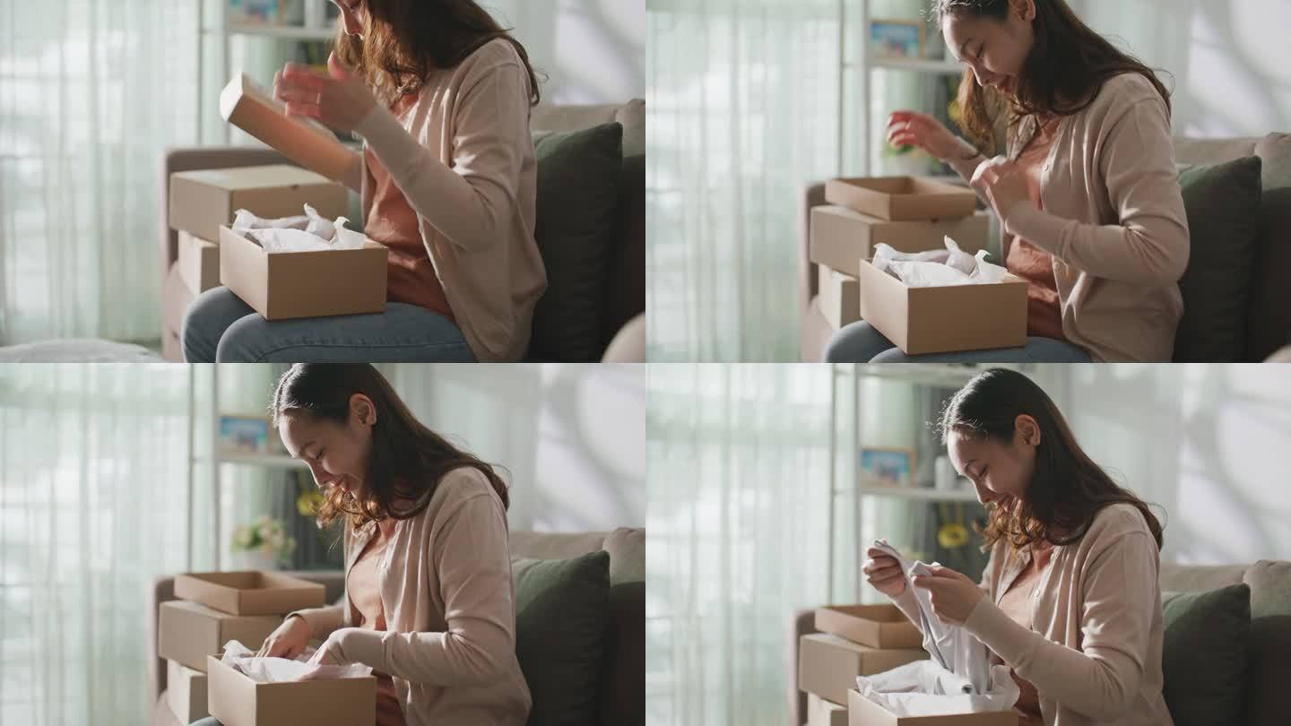 一名亚洲女子收到了一个纸板箱，用于网购和送货到家