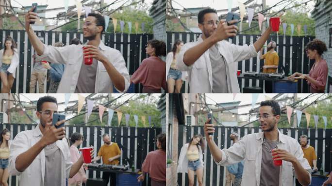有魅力的非洲裔美国人跳舞，有说有笑，在街头咖啡馆用智能手机进行在线视频通话
