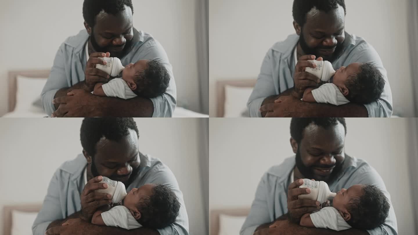一位非洲父亲在家里把奶瓶里的牛奶拿出来喂他的小男婴。