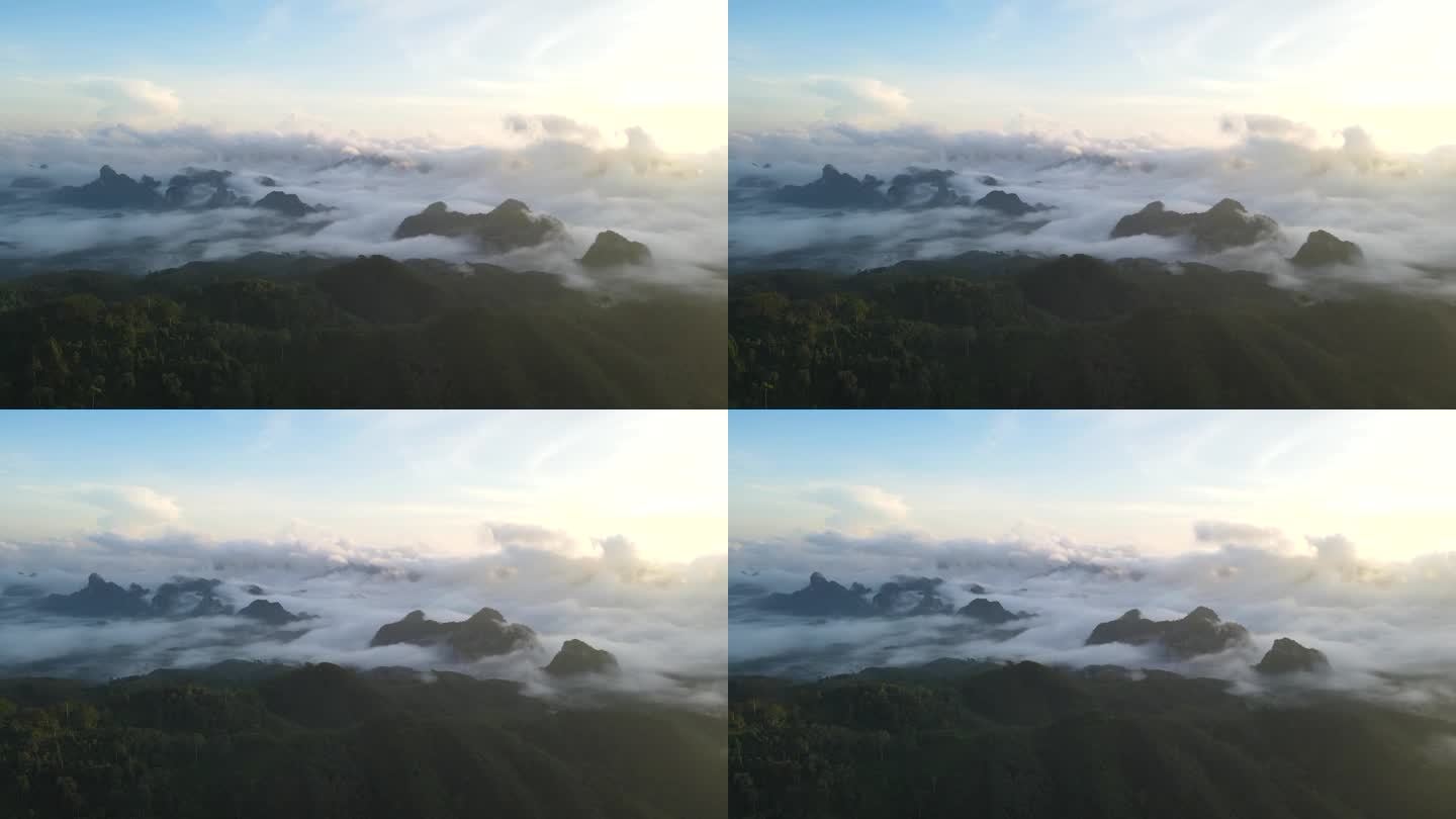 在日出时与雾流一起飞越局部山脉。航拍视频