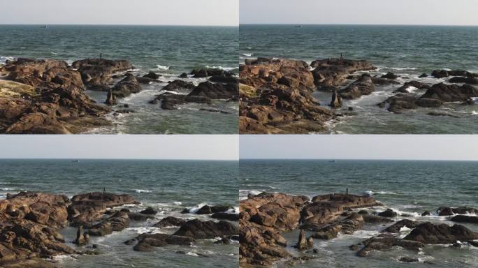 在越南美奈，无人驾驶飞机环绕着一名独自冲浪的男子。戏剧性的海浪冲击着岩石海岸。