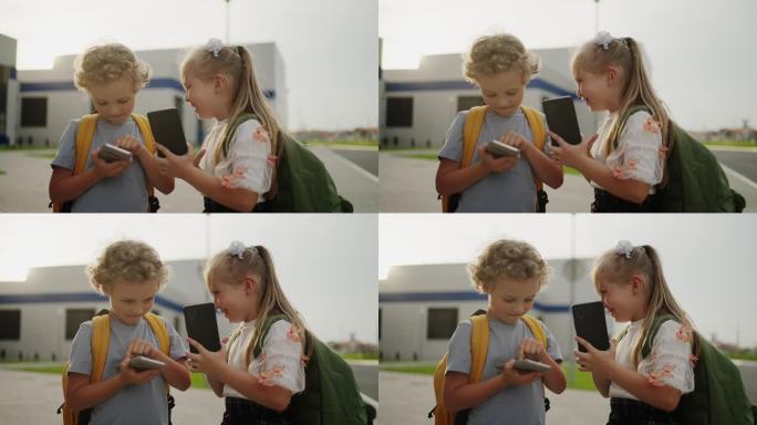 放学后的小同学，可爱的男生和女生在课间玩智能手机聊天