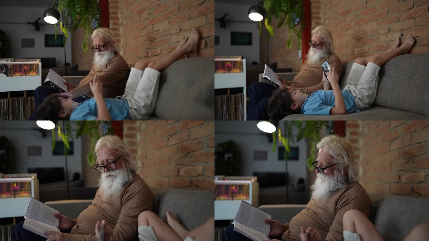 爷爷在看书，孙子在家里玩数码平板电脑