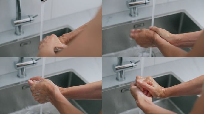 一个女人往手上抹肥皂，在厨房里洗手