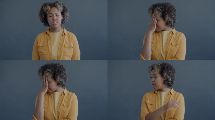 在灰色背景上，羞愧的非裔美国妇女做鬼脸的慢动作手势