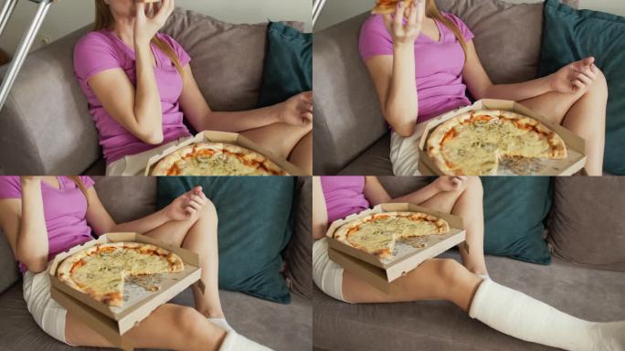 腿上打石膏的女人坐在沙发上吃披萨
