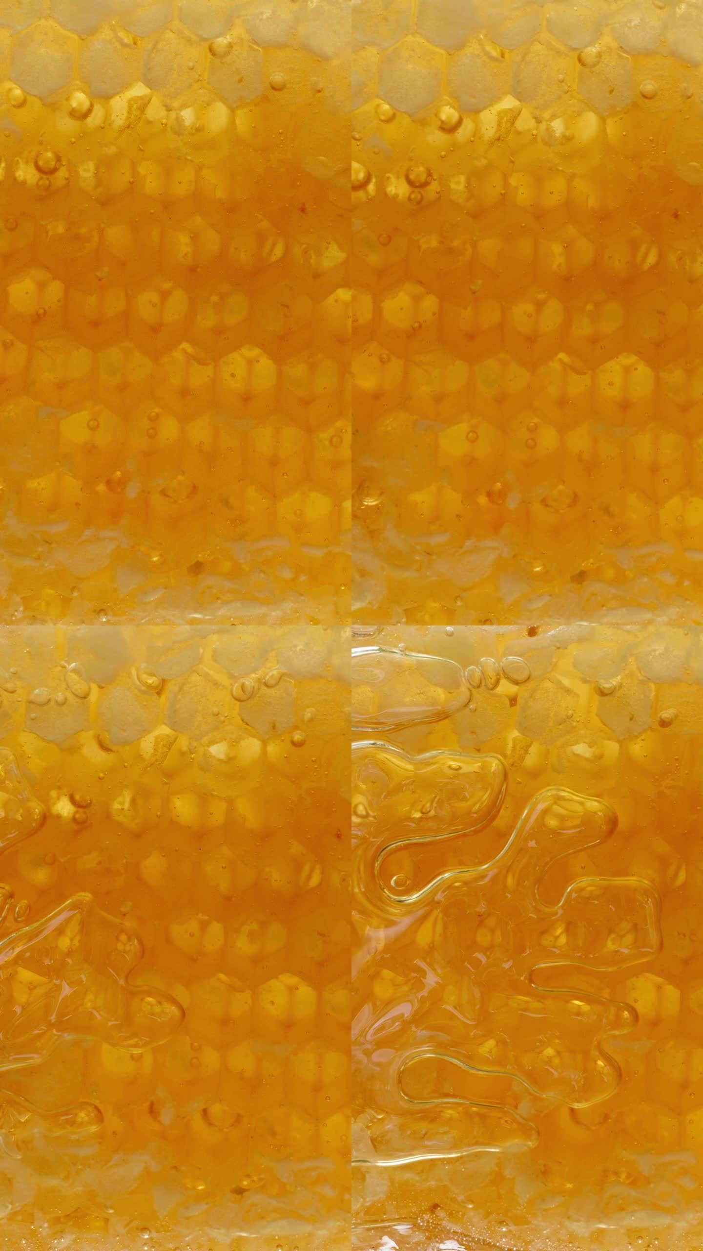我从盘子里拿出一块金色的蜂窝片，打开它，它慢慢地渗出蜂蜜。从下面看宏观。垂直视频。
