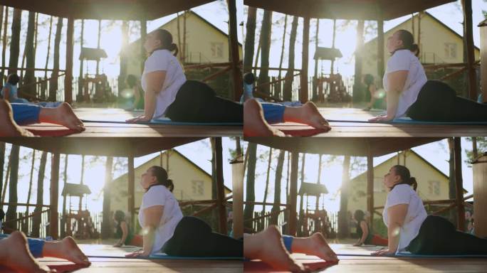 超重妇女在减肥营做体育锻炼，练习瑜伽，健康的生活方式