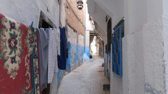 摩洛哥丹吉尔:麦地那古雅的小巷，晾着的衣服和老旧的门。