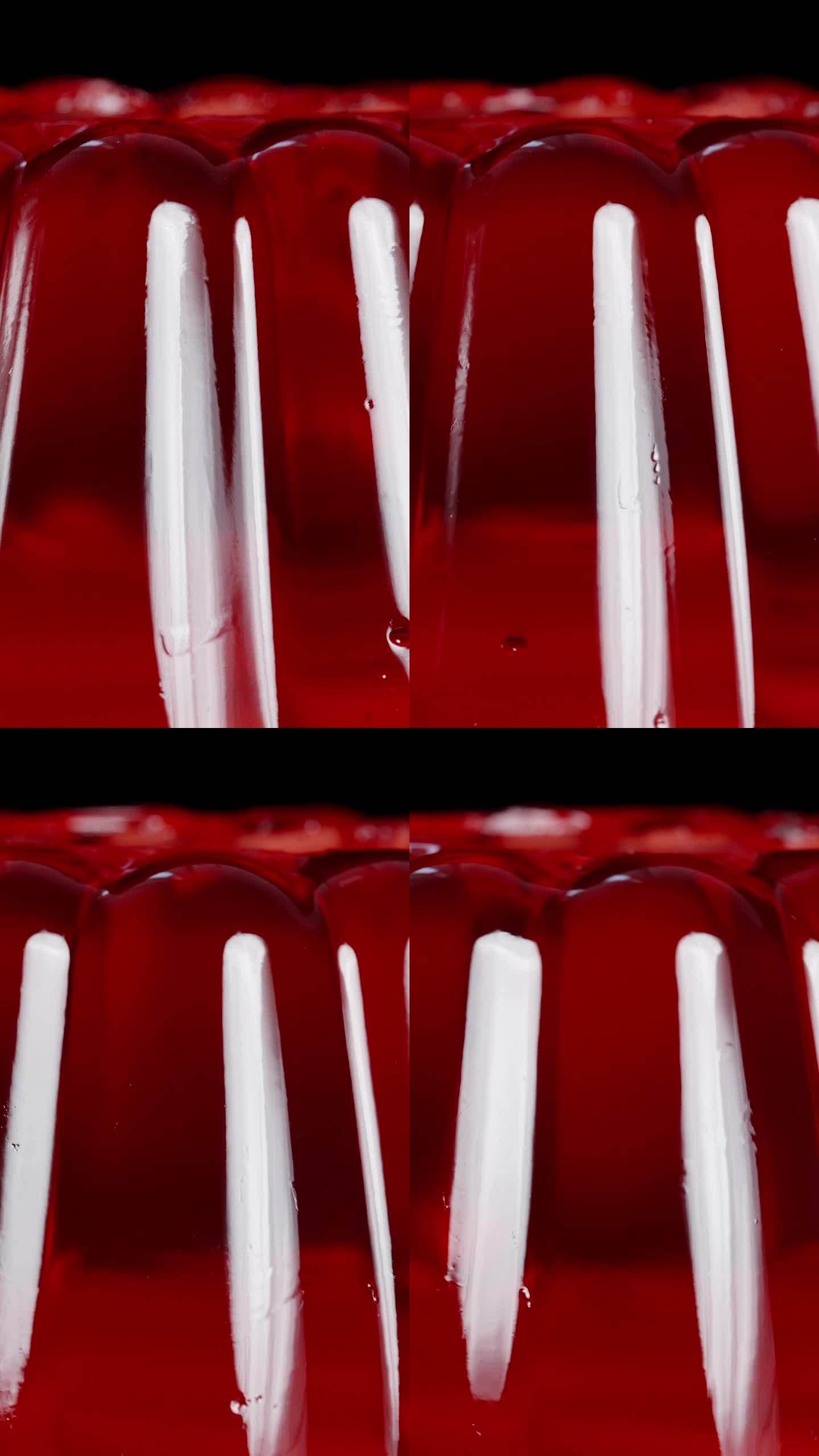 垂直视频。经典形状的颤抖红色果冻特写。