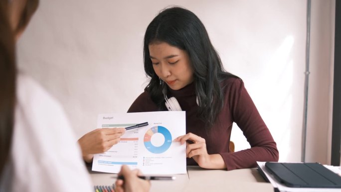 迷人的亚洲大学生使用笔记本电脑和平板电脑与一群朋友一起学习英语课堂，社交媒体和教育理念。