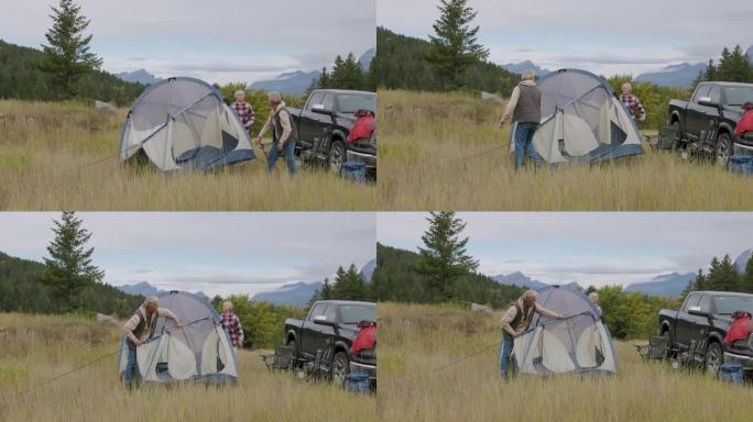 成熟的夫妇在草地上搭起帐篷