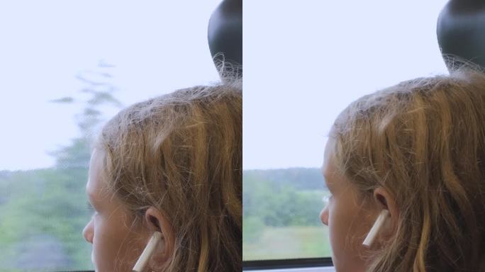 小女孩在火车上望着窗外