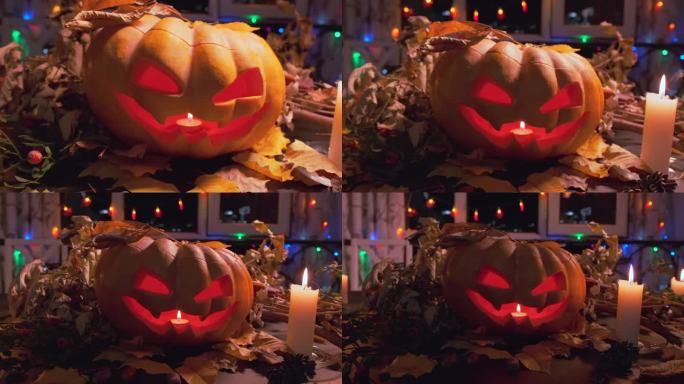 秋天的节日背景，令人毛骨悚然的可怕雕刻南瓜与摇曳的蜡烛在干燥的秋叶