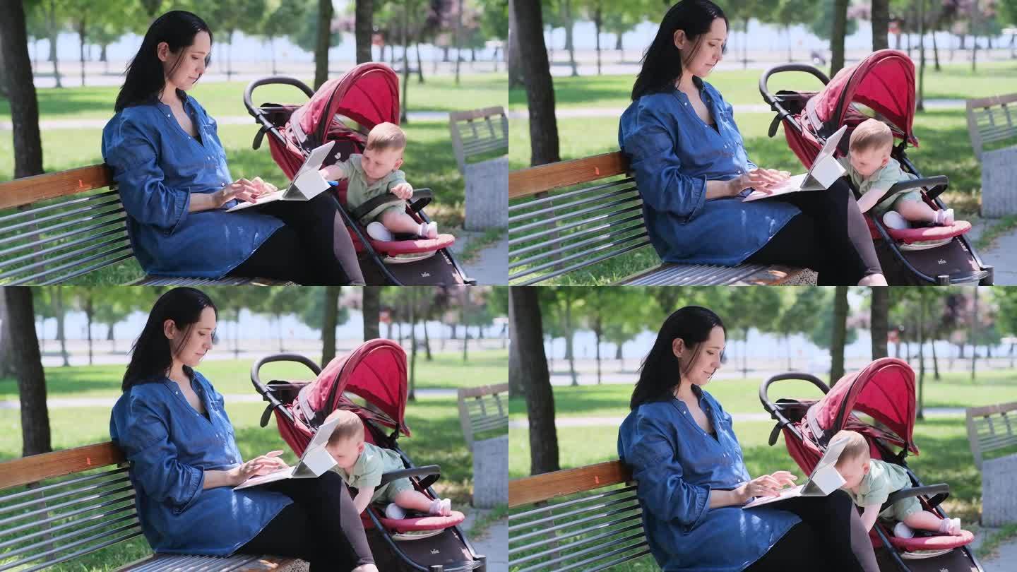 女士用键盘在平板电脑上书写文字，活跃的婴儿从公园的婴儿车里出来