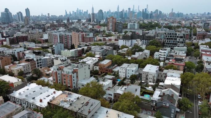 公寓大楼与纽约布鲁克林的曼哈顿天际线形成鲜明对比。在纽约威廉斯堡附近。航拍镜头与倒镜头运动