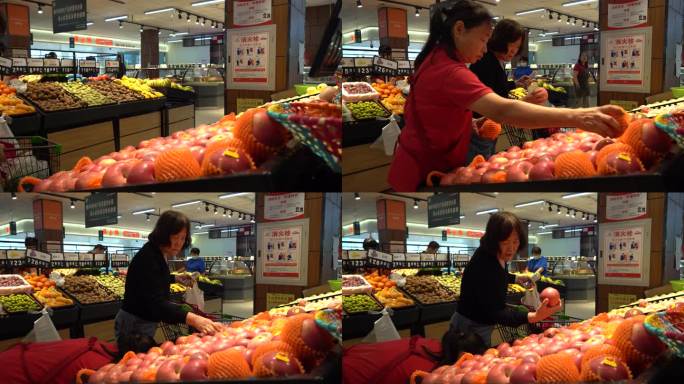 现代化大型超市水果专区挑选苹果