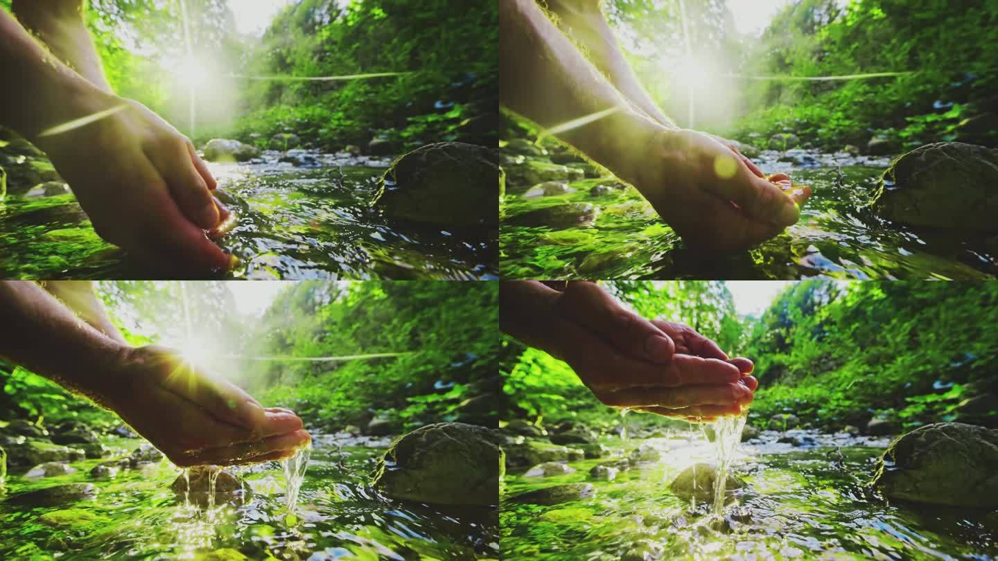 男子在树林里的河里伸手取水