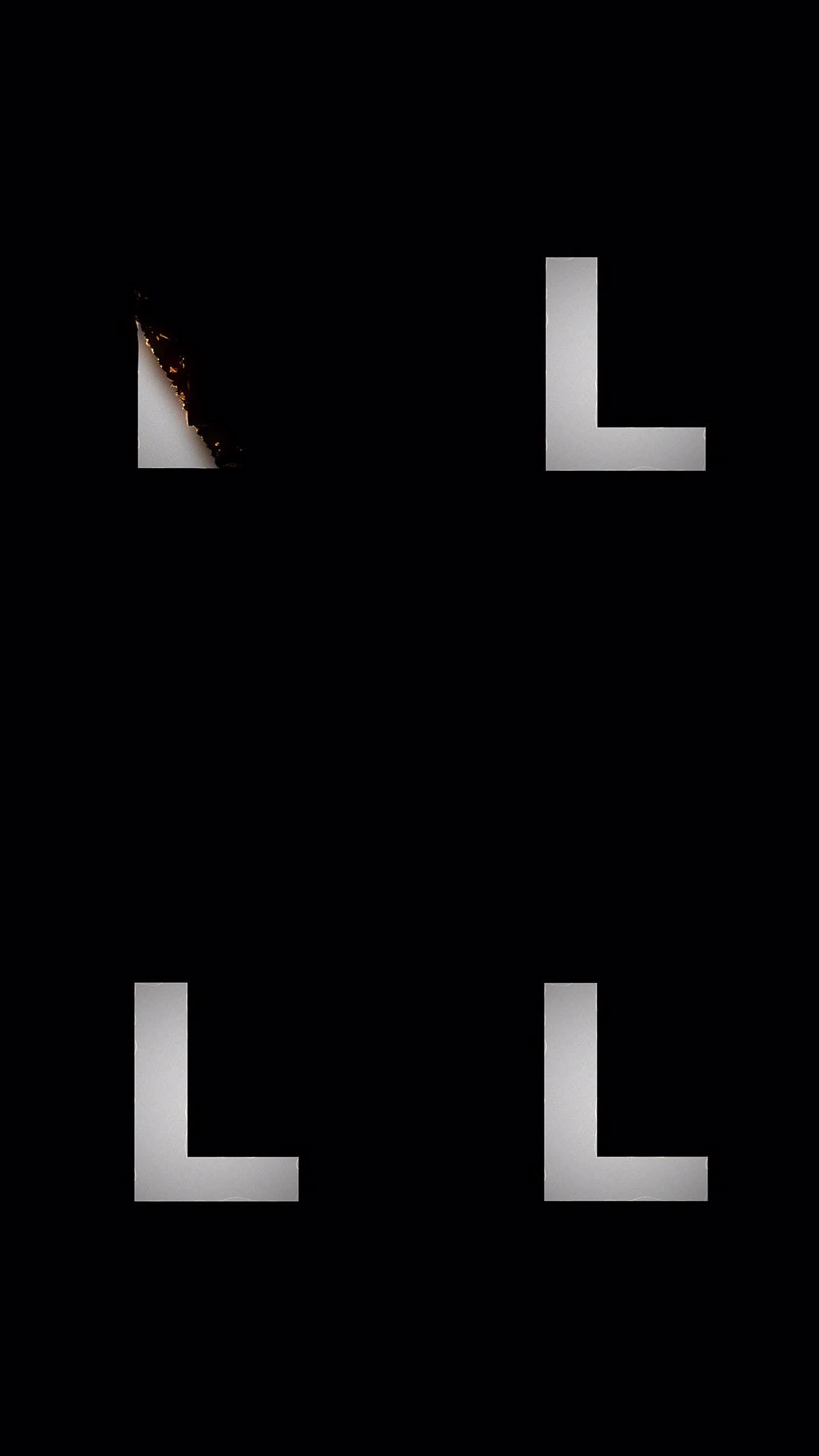 火字母显示和消失动画。L符号燃烧像纸烬和烟在黑色的背景。设计元素