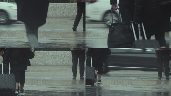 提着行李箱的人站在人行横道上