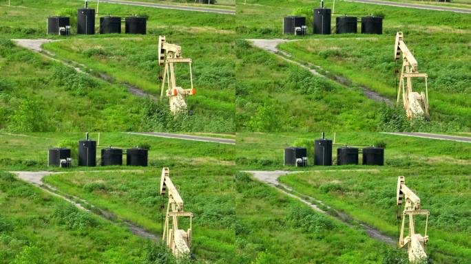 原油油井。航空拍摄的储油罐，用于储存泵出的石油，和油井抽出石油在美国农村地面。