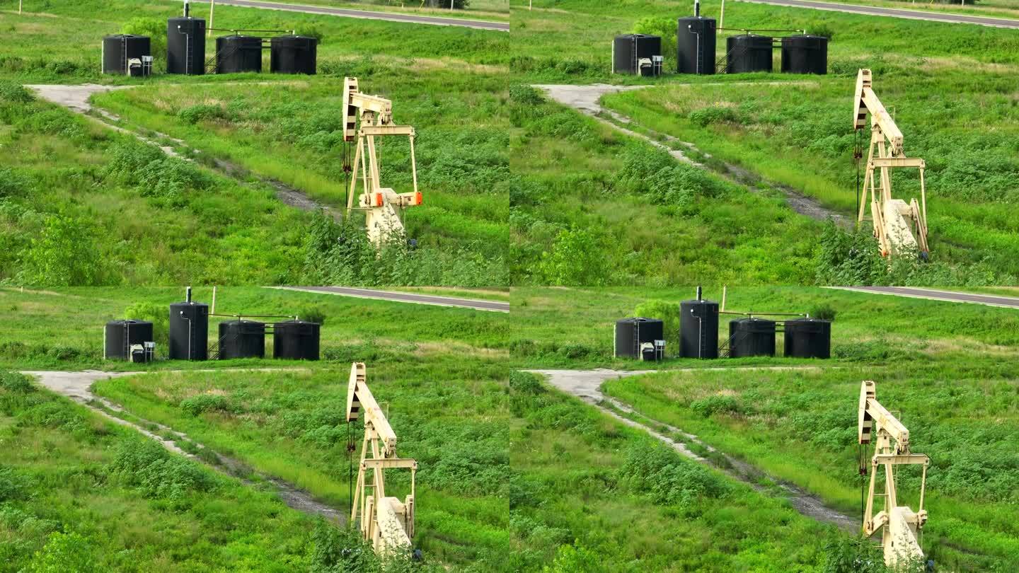 原油油井。航空拍摄的储油罐，用于储存泵出的石油，和油井抽出石油在美国农村地面。