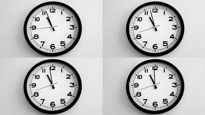 白色挂钟上的白色钟面特写，箭头显示23.00或11.00