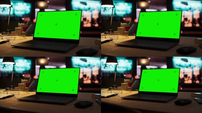 缩小镜头的笔记本电脑站在一个绿色屏幕Chromakey模拟显示器的木桌上。创意机构游戏开发者和平面设
