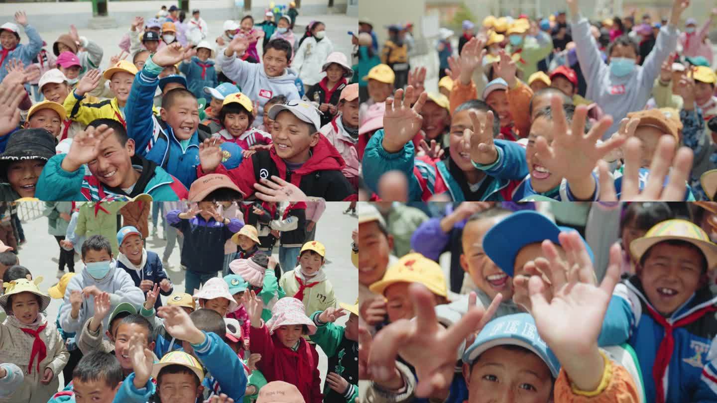 一群藏族小学生对着镜头招手