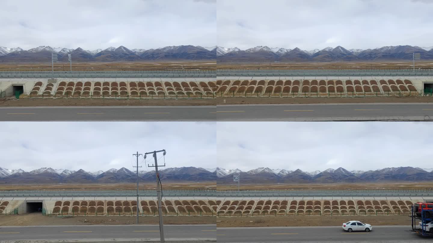 青藏铁路火车窗外雪山下的高速公路