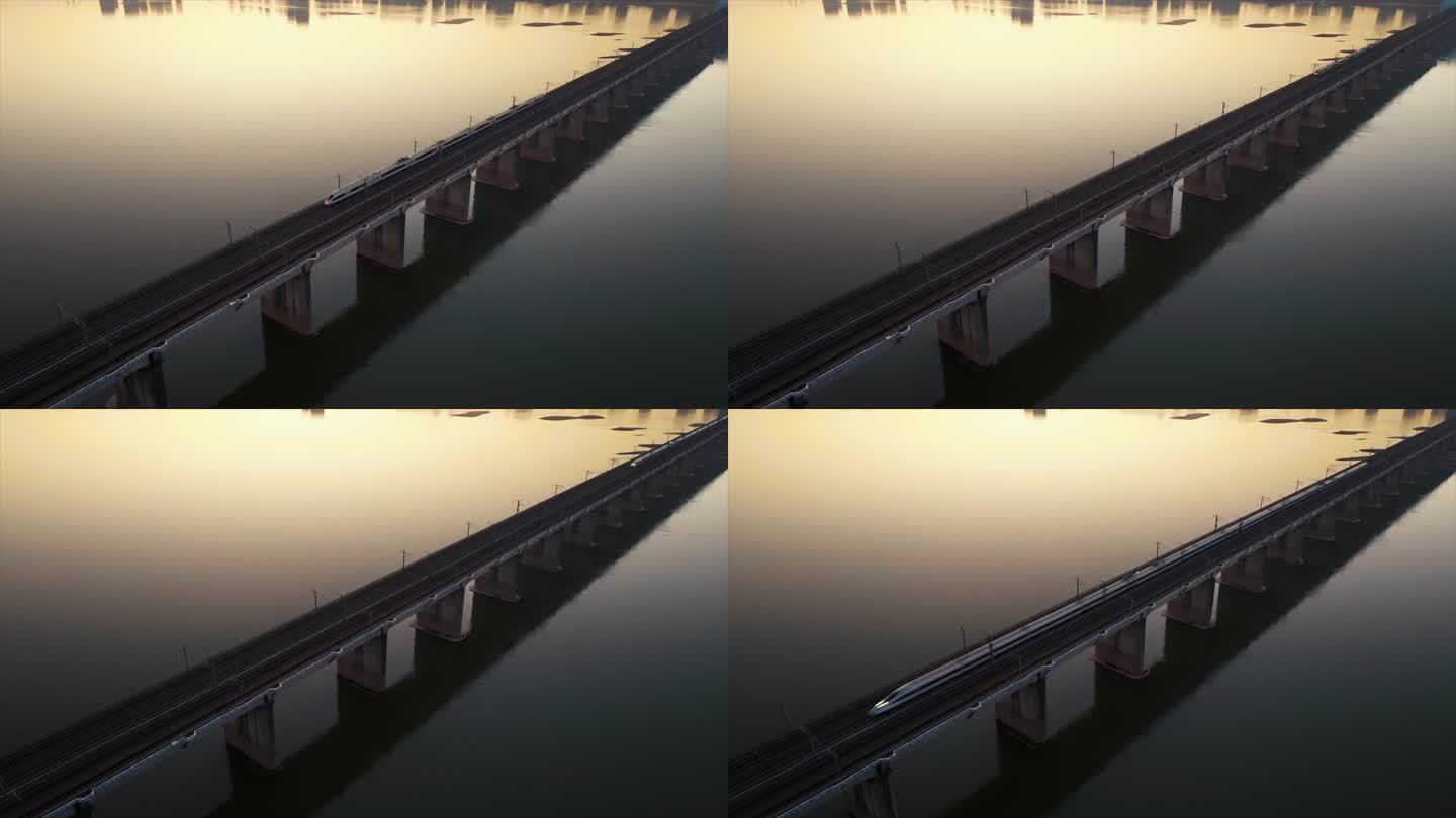 黎明日出前的高铁行驶在跨江大桥上