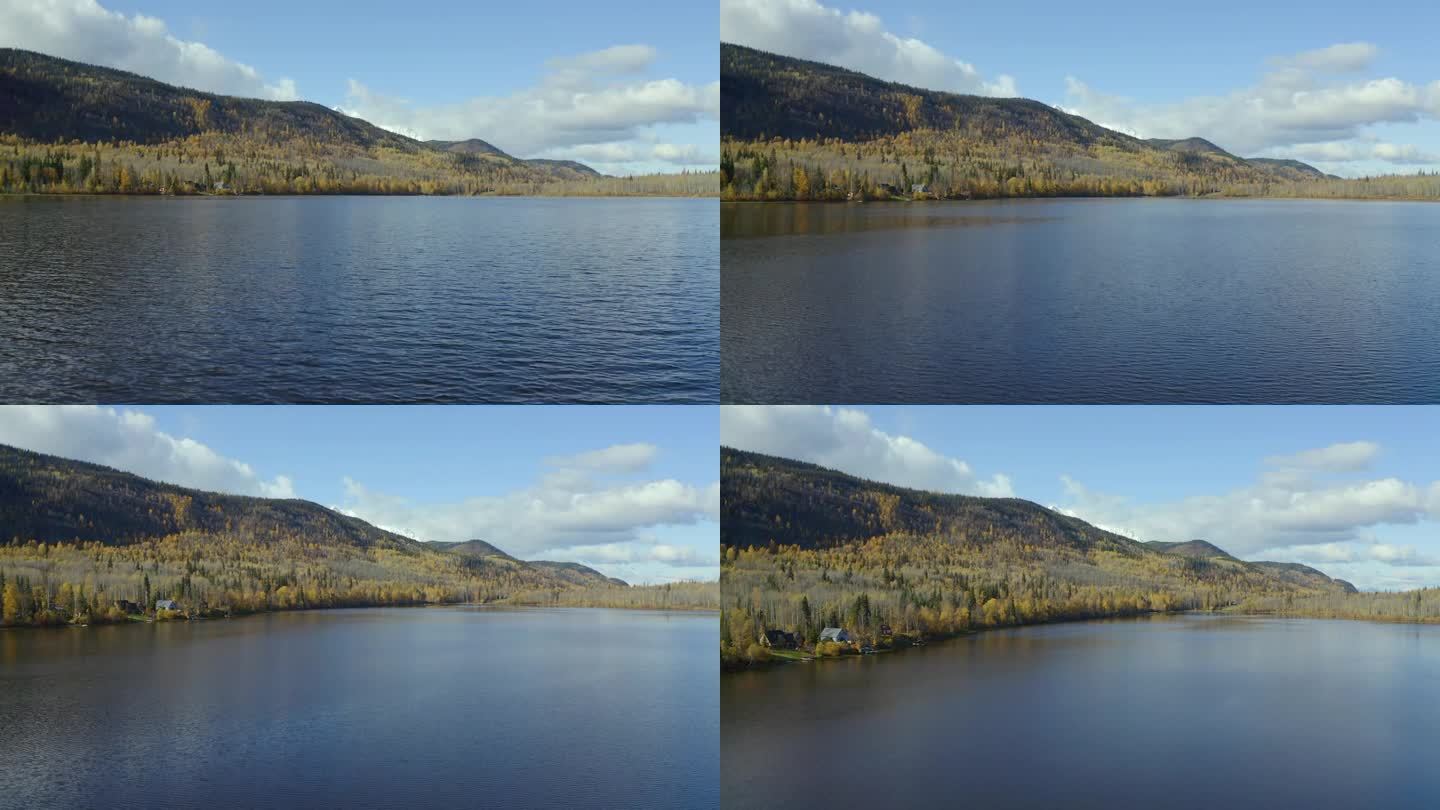 靠近水面缓缓上升的移动无人机拍摄的西摩湖在史密瑟斯，北不列颠哥伦比亚省(BC)地区在秋天的几个月。