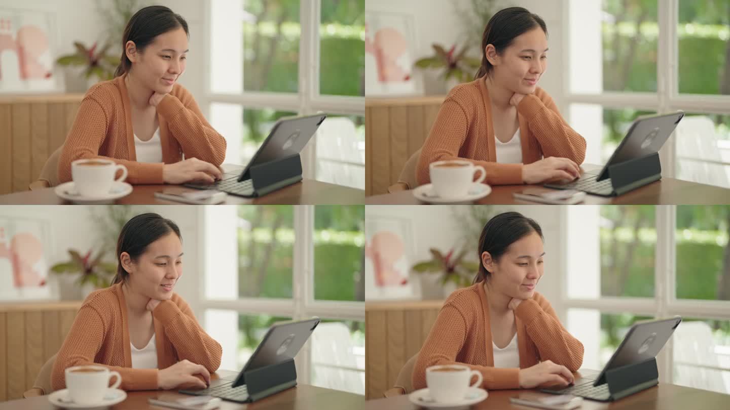 一个女人在咖啡馆用笔记本电脑