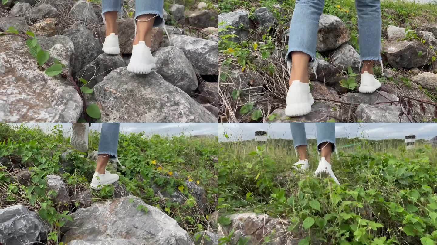 穿白鞋走在石头上的女人。