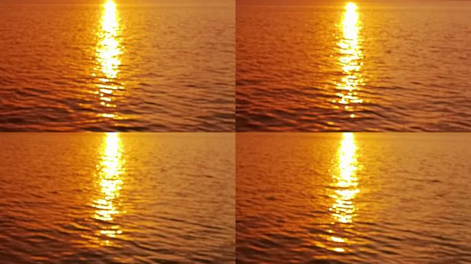 金色晚霞映射在水面上的倒影波光粼粼