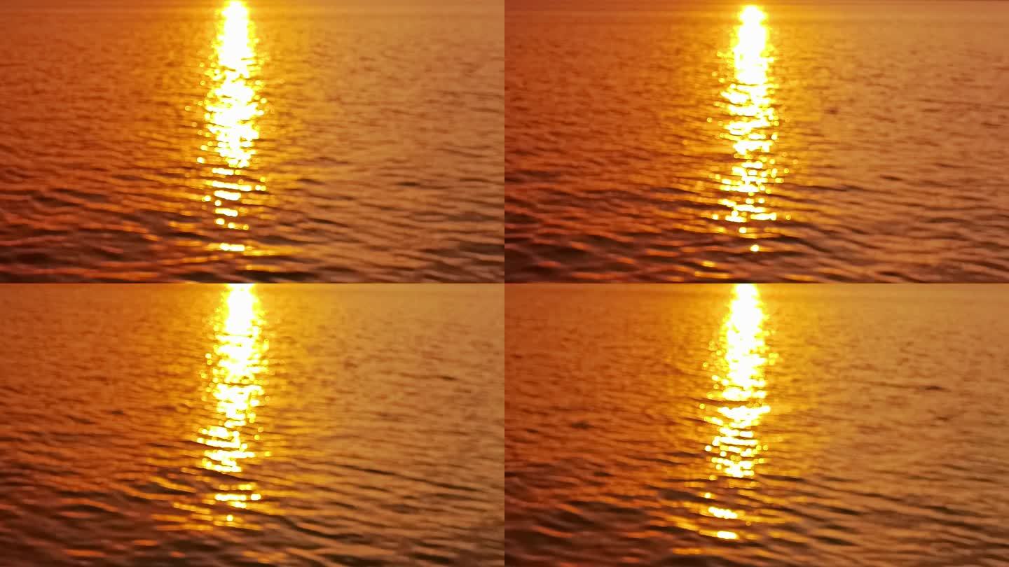 金色晚霞映射在水面上的倒影波光粼粼
