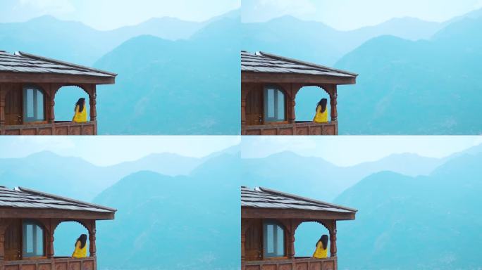 在印度喜马偕尔邦的马纳里，印度游客女孩站在纳格尔城堡，背景是山脉。旅游度假概念。