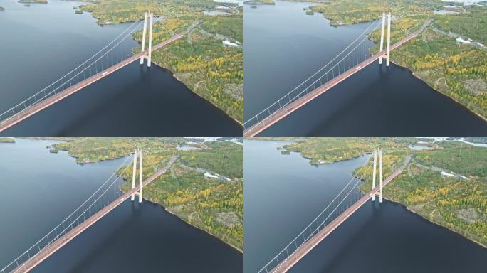 鸟瞰车辆通过Hogakustenbron大桥，俯瞰瑞典宁静的大海和秋天的森林。