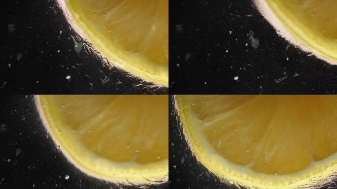 一片柠檬片与蜂蜜一起在玻璃上滑动，并与柠檬汁溶解在一起，黑色背景下的微距镜头。