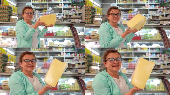 一个成熟的女店员在超市拿着奶酪的肖像