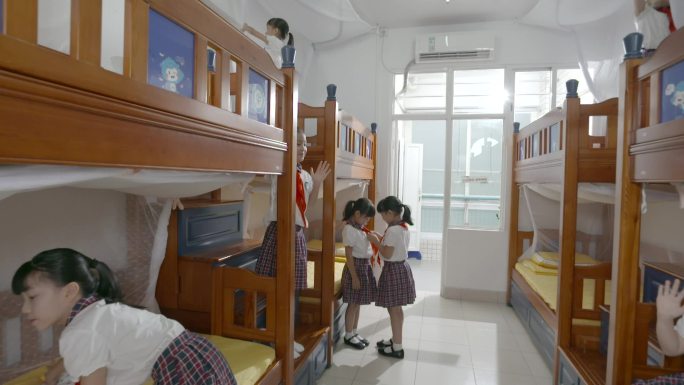 小学生整理宿舍内务叠被佩戴红领巾集体宿舍