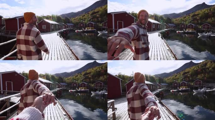 他牵着同伴的手，在挪威的一个渔村领路