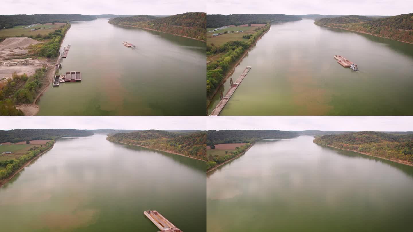 无人机拍摄的大沙船行驶在俄亥俄河上，靠近河岸上的一个沙矿
